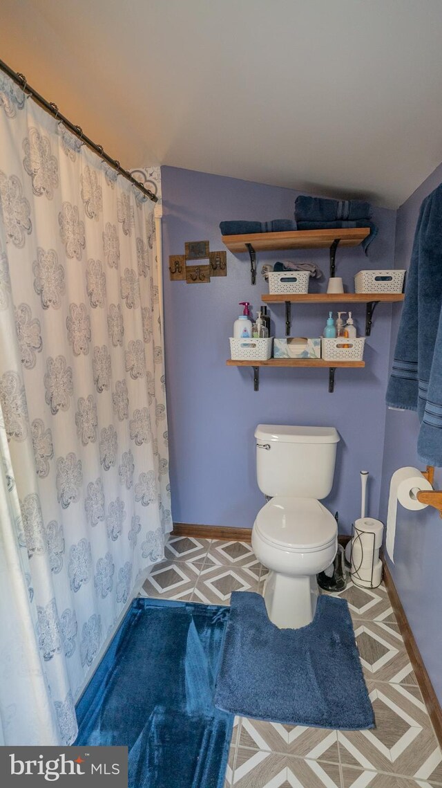 718 Walnut St, Royersford, PA 19468 - bathroom featuring toilet, baseboards, and a shower with shower curtain