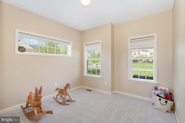 rec room featuring carpet floors, baseboards, and visible vents