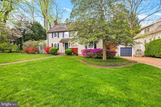 3614 N Abingdon St, Arlington, VA 22207 - view of front facade with a chimney, driveway, and a front lawn