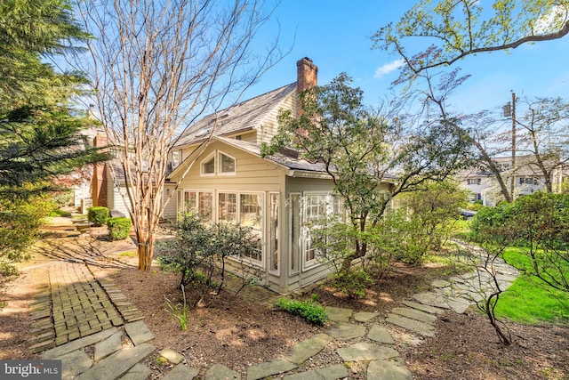 3614 N Abingdon St, Arlington, VA 22207 - view of home's exterior with a sunroom and a chimney