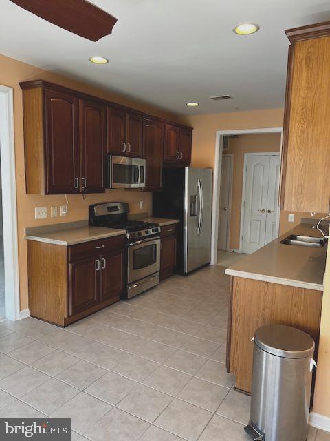 1402 Joppa Forest Dr Unit 12, Joppa, MD 21085 - kitchen with appliances with stainless steel finishes, a sink, light countertops, light tile patterned floors, and visible vents