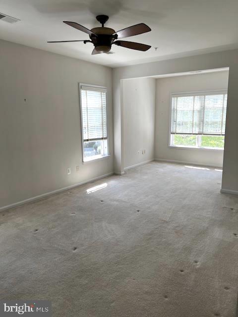 1402 Joppa Forest Dr Unit 12, Joppa, MD 21085 - carpeted spare room featuring baseboards, ceiling fan, a wealth of natural light, and visible vents