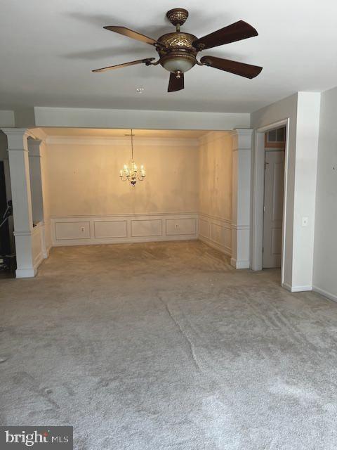 1402 Joppa Forest Dr Unit 12, Joppa, MD 21085 - unfurnished living room with light carpet, ceiling fan with notable chandelier, and a decorative wall