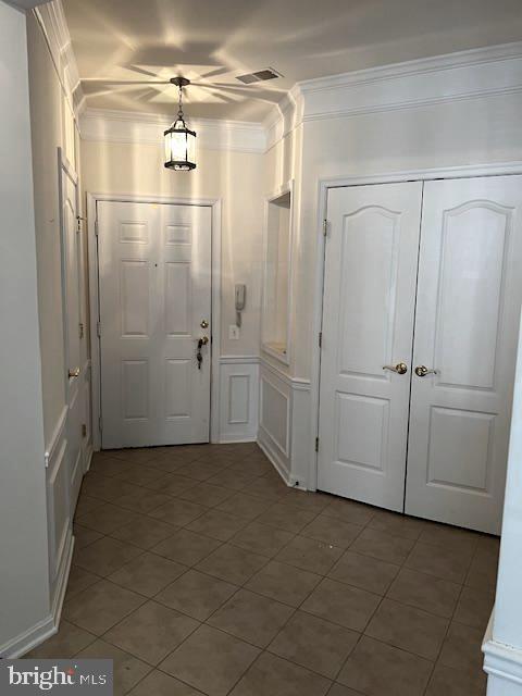 1402 Joppa Forest Dr Unit 12, Joppa, MD 21085 - entrance foyer featuring crown molding, tile patterned floors, visible vents, and a decorative wall