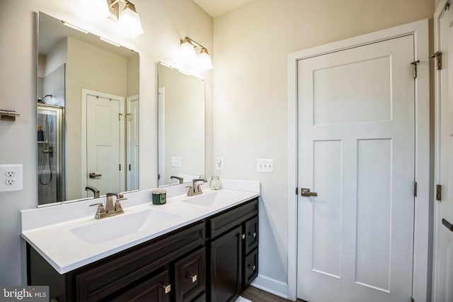 9008 Waller Tree Way, Upper Marlboro, MD 20772 - bathroom featuring double vanity, baseboards, a shower with door, and a sink