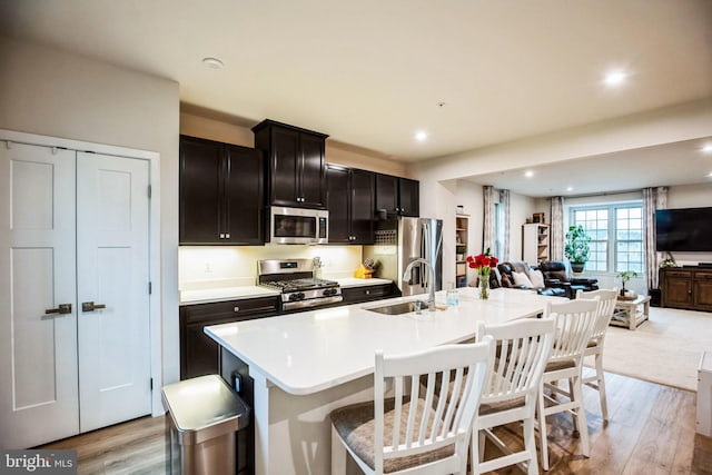 9008 Waller Tree Way, Upper Marlboro, MD 20772 - kitchen featuring a sink, appliances with stainless steel finishes, open floor plan, and light wood-type flooring