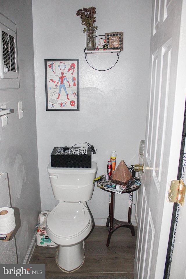 bathroom with toilet, wood finished floors, and baseboards