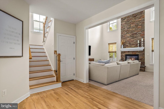 living room featuring baseboards, plenty of natural light, and a fireplace
