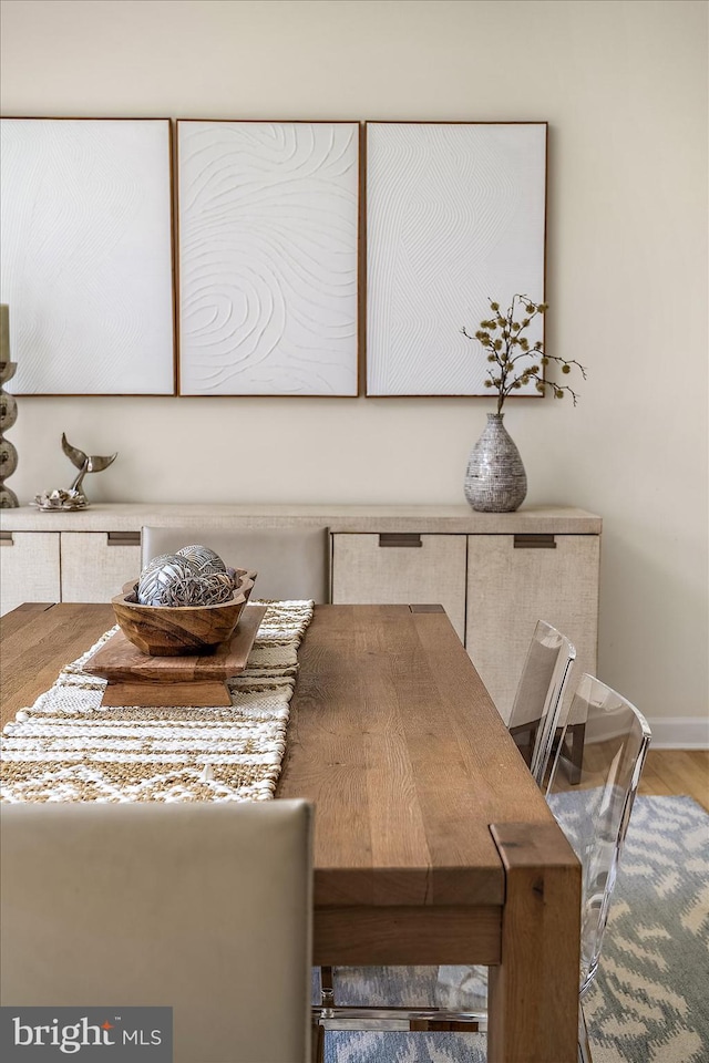 dining area with wood finished floors