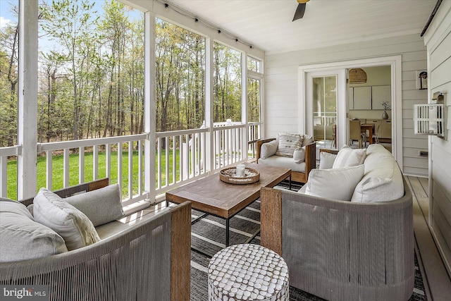sunroom with ceiling fan and an outdoor hangout area