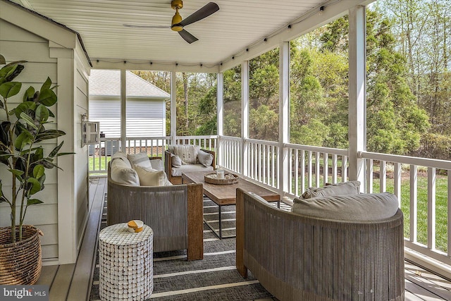 sunroom / solarium featuring rail lighting, ceiling fan, and outdoor lounge area