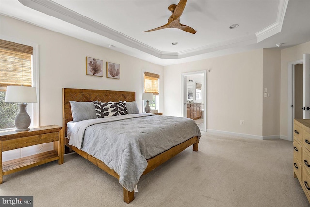 bedroom with crown molding, multiple windows, light carpet, and a tray ceiling