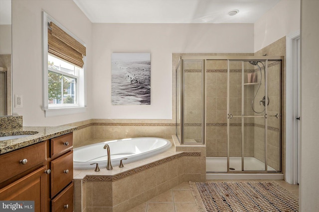 full bath with vanity, a bath, tile patterned flooring, and a stall shower