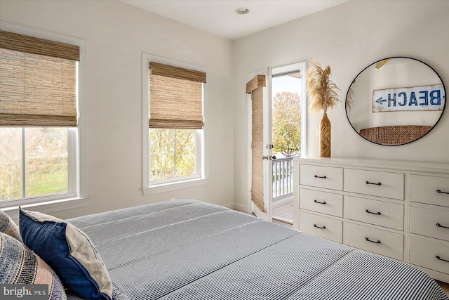 bedroom featuring baseboards and multiple windows