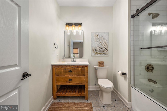 bathroom with vanity, tile patterned floors, baseboards, and toilet