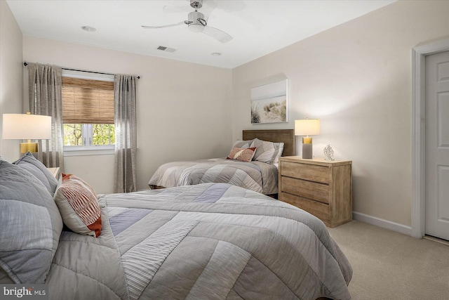 bedroom featuring light colored carpet, a ceiling fan, baseboards, and visible vents