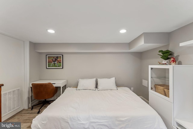 bedroom featuring visible vents, recessed lighting, and wood finished floors