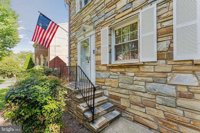 entrance to property with stone siding