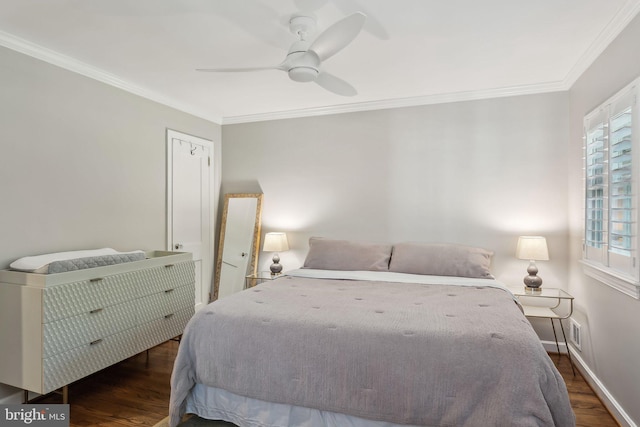 bedroom featuring baseboards, ornamental molding, a ceiling fan, and wood finished floors