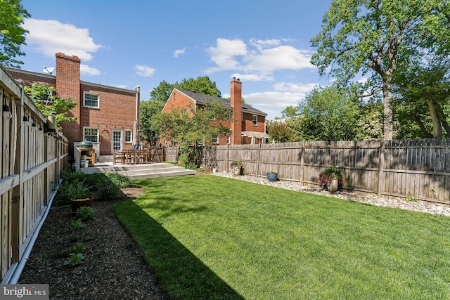 view of yard with a fenced backyard and a wooden deck