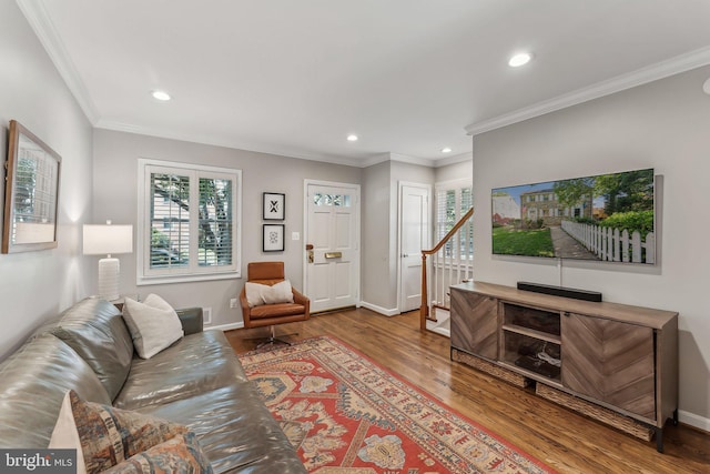 living room featuring stairs, wood finished floors, baseboards, ornamental molding, and recessed lighting