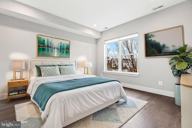 bedroom with recessed lighting, dark wood-type flooring, visible vents, and baseboards