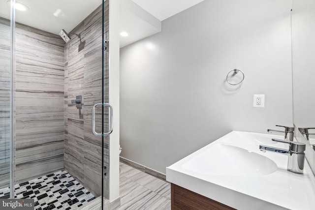 bathroom featuring baseboards, a sink, recessed lighting, and a stall shower