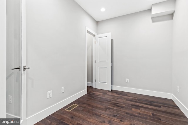 unfurnished bedroom with recessed lighting, dark wood finished floors, visible vents, and baseboards
