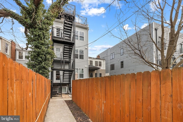 exterior space featuring fence and stairs