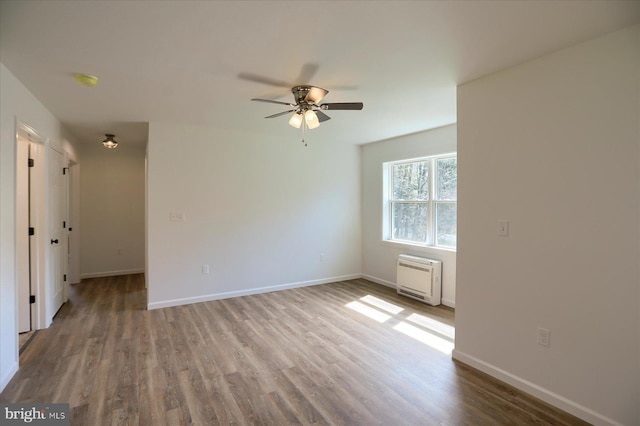3497 New Lancaster Valley Rd, Milroy, PA 17063 - empty room featuring wood finished floors, ceiling fan, heating unit, and baseboards