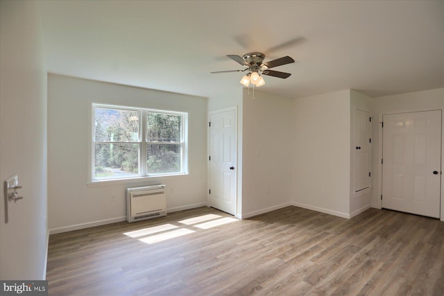 3497 New Lancaster Valley Rd, Milroy, PA 17063 - unfurnished room featuring baseboards, heating unit, a ceiling fan, and wood finished floors