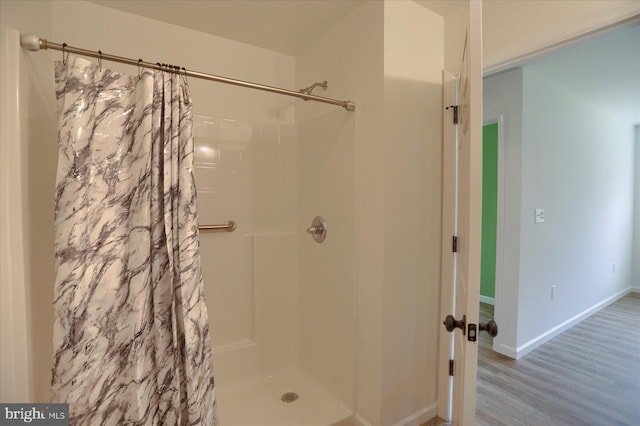 3497 New Lancaster Valley Rd, Milroy, PA 17063 - bathroom with baseboards, wood finished floors, and a shower with shower curtain