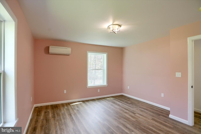 3497 New Lancaster Valley Rd, Milroy, PA 17063 - unfurnished room featuring an AC wall unit, wood finished floors, and baseboards