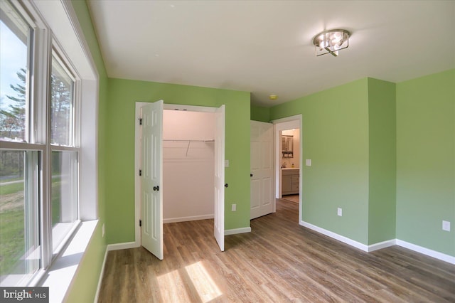 3497 New Lancaster Valley Rd, Milroy, PA 17063 - unfurnished bedroom featuring baseboards, wood finished floors, and a walk in closet
