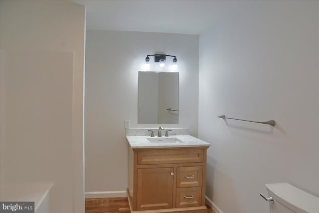 3497 New Lancaster Valley Rd, Milroy, PA 17063 - bathroom featuring baseboards, wood finished floors, toilet, and vanity