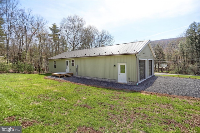 3497 New Lancaster Valley Rd, Milroy, PA 17063 - rear view of property featuring a detached garage, a wooden deck, metal roof, and a yard