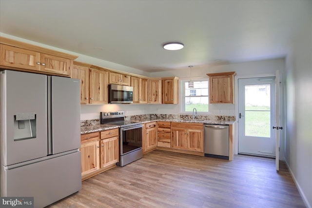 3497 New Lancaster Valley Rd, Milroy, PA 17063 - kitchen featuring a sink, stainless steel appliances, light brown cabinets, light wood-style flooring, and light stone counters