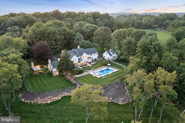 bird's eye view featuring a wooded view