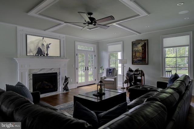 living room featuring ceiling fan, a premium fireplace, french doors, baseboards, and wood finished floors