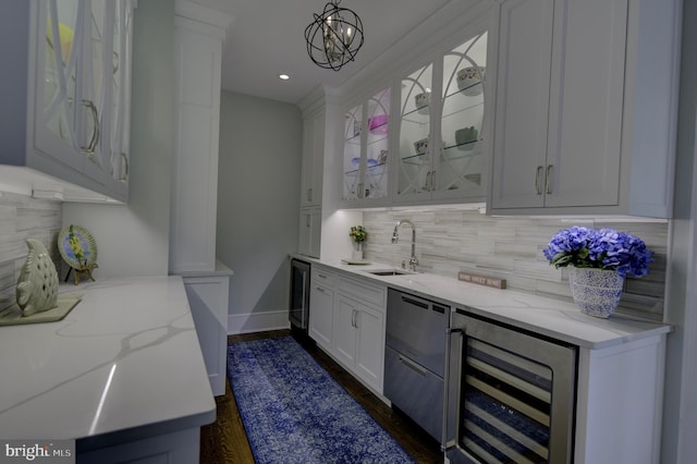 bar featuring decorative backsplash, wet bar, a sink, dark wood-style floors, and wine cooler
