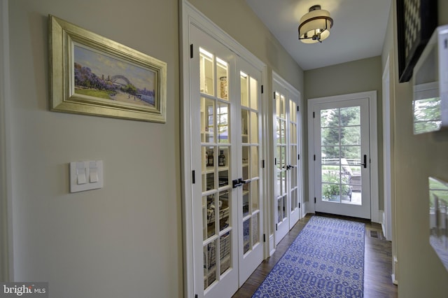 doorway to outside with french doors, dark wood-style floors, and visible vents