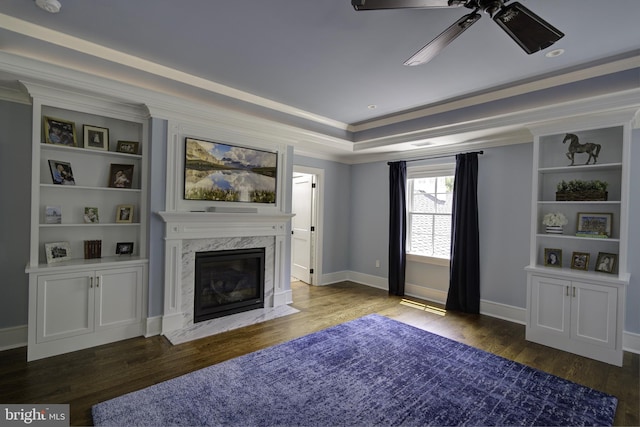 sitting room featuring crown molding, a fireplace, a ceiling fan, baseboards, and wood finished floors