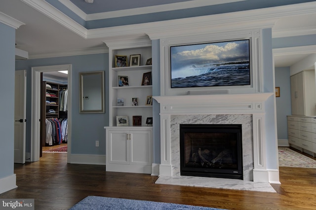 living room with baseboards, ornamental molding, wood finished floors, and a premium fireplace