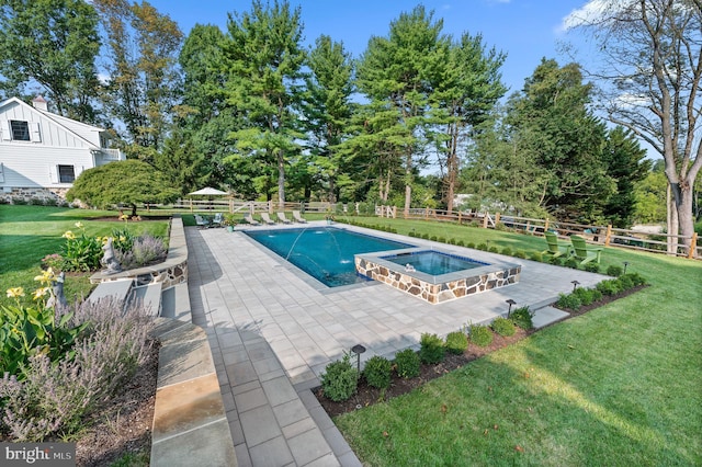 view of pool with a yard, a patio, a pool with connected hot tub, and fence