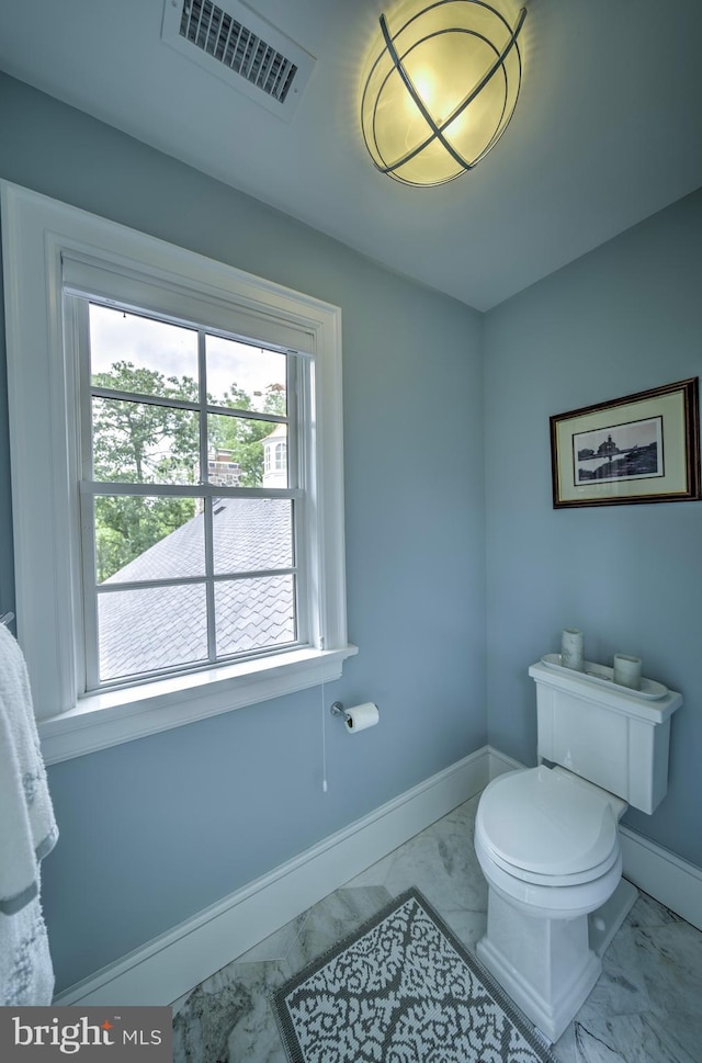 bathroom with visible vents, marble finish floor, baseboards, and toilet