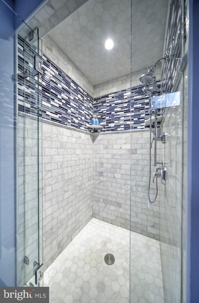 full bathroom featuring recessed lighting and a shower stall