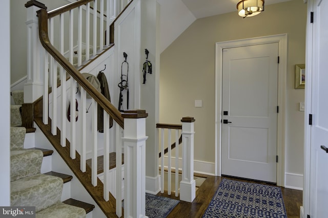 entrance foyer with baseboards, stairs, and wood finished floors
