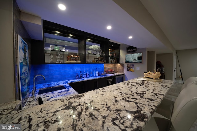 bar featuring recessed lighting, wet bar, decorative backsplash, and a sink