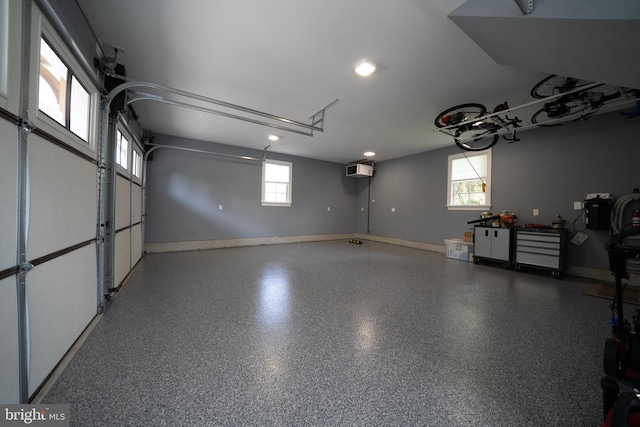garage featuring recessed lighting and baseboards