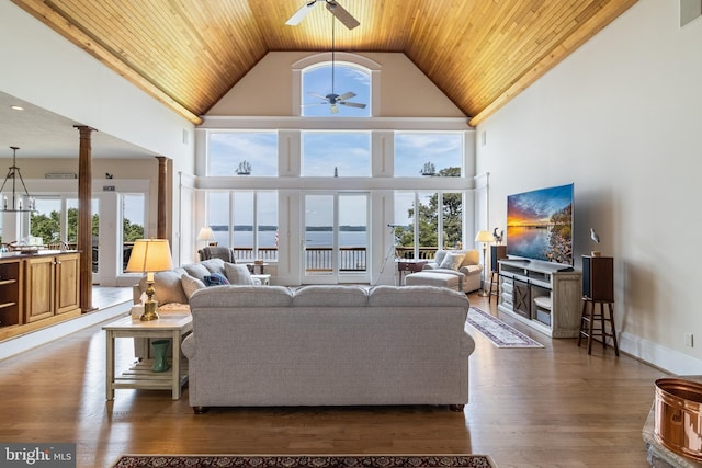 living room featuring wood ceiling, decorative columns, high vaulted ceiling, a ceiling fan, and dark wood-type flooring